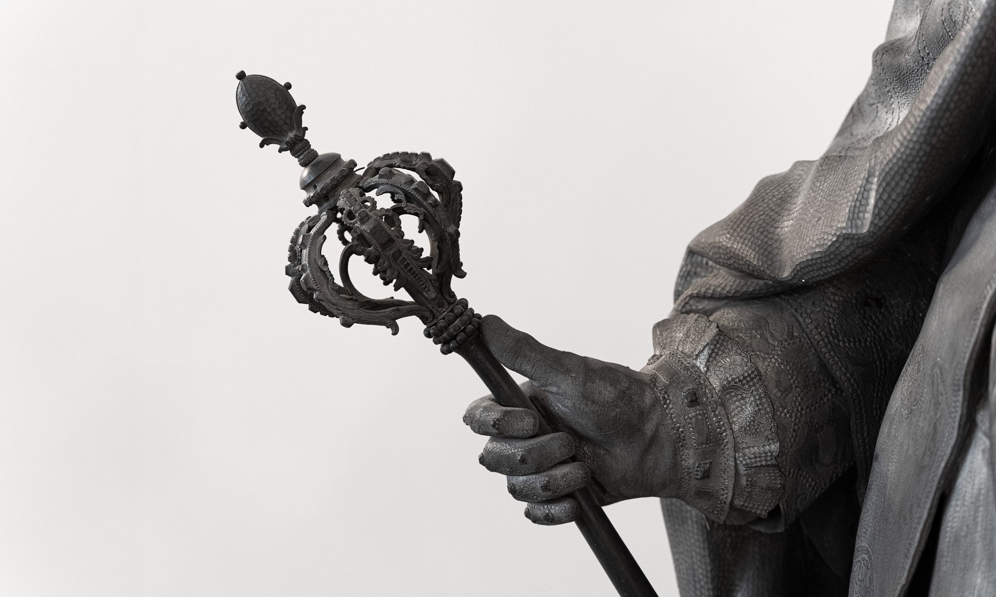 photograph of statue holding scepter