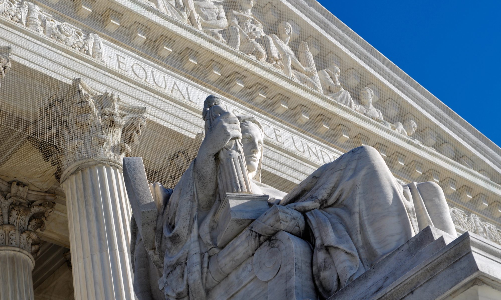 photograph of statue in front of Supreme Court building