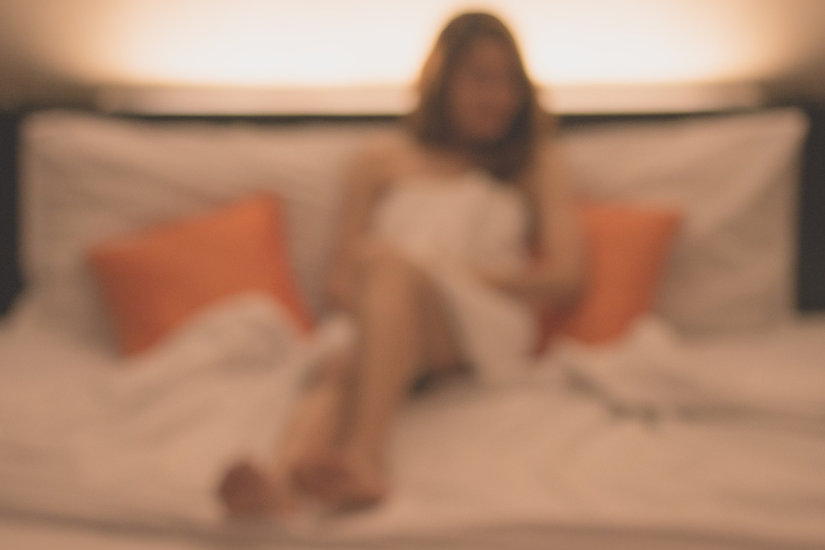 blurred image of woman on bed